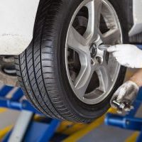 car wheel tire replacement by mechanic in the garage